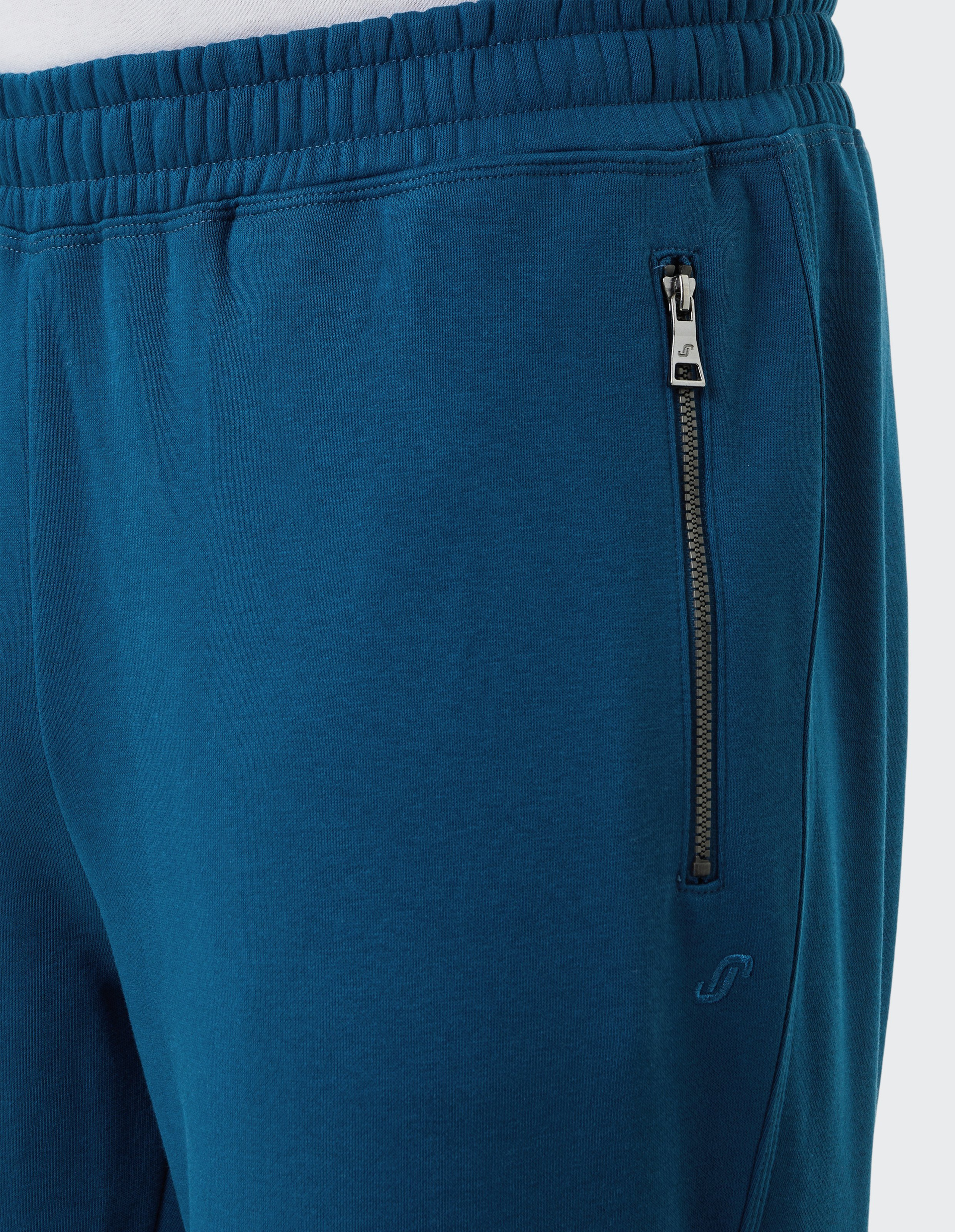 Dunkelblaue Jogginghose mit elastischem Bund und einer Reißverschlusstasche auf der rechten Seite, aus weichem Stoff.