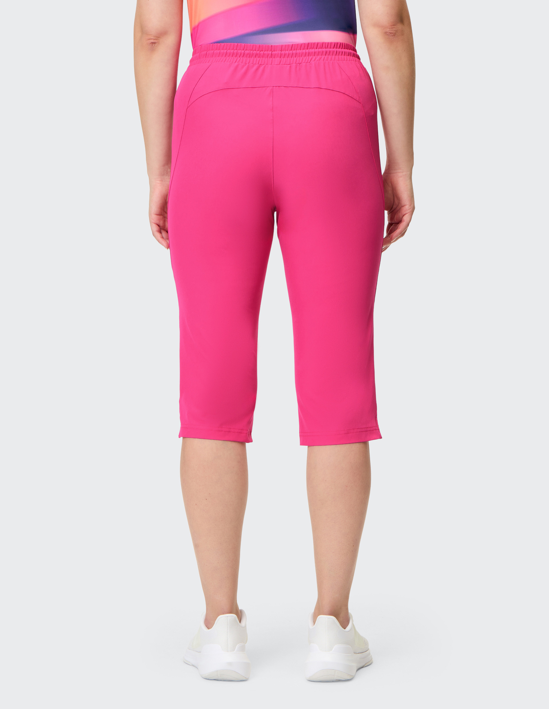 Leuchtend pinke Dreiviertelhose mit elastischem Bund und Kordelzug, schlichtes Design ohne Muster, aus weichem Stoff.