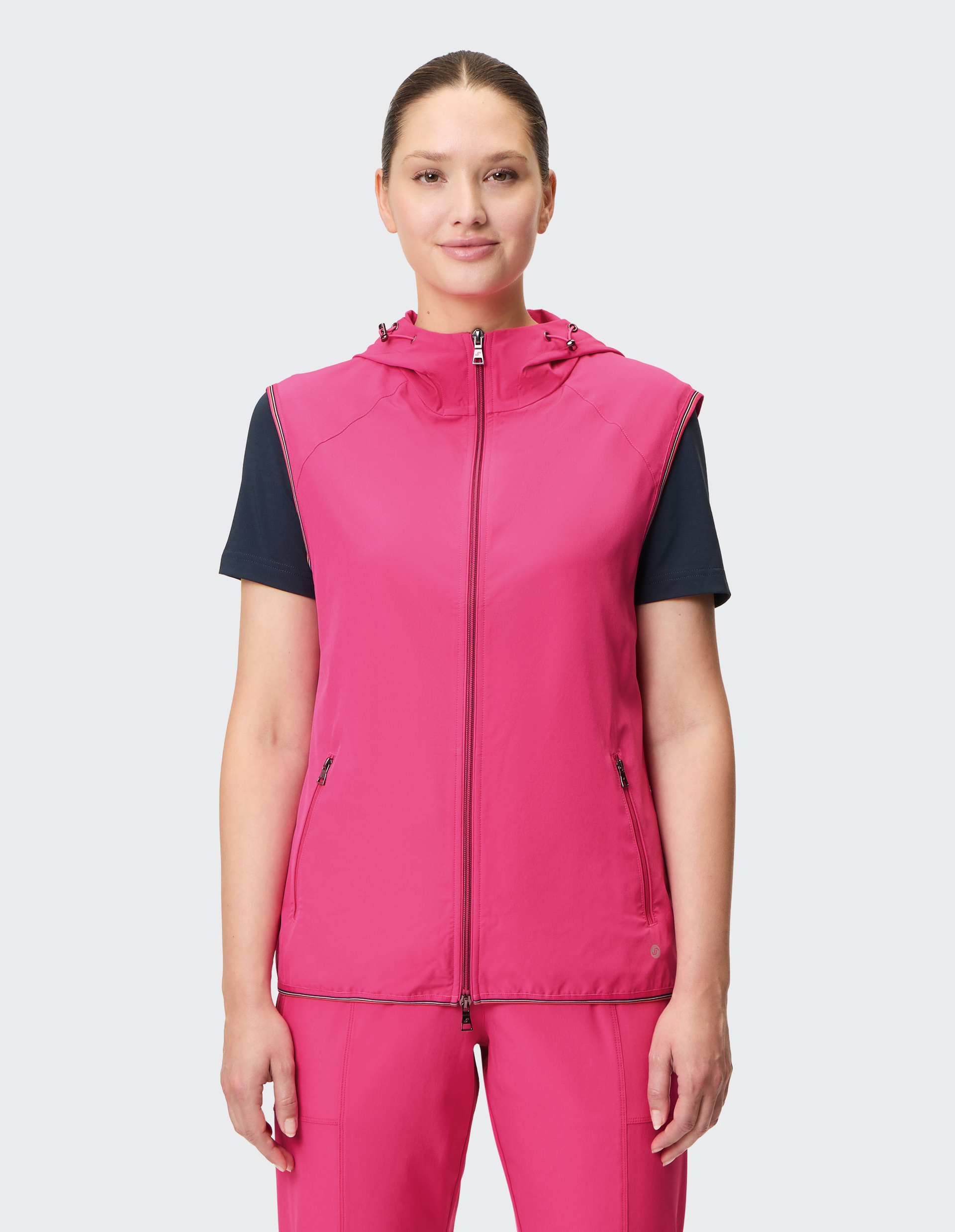 Ärmellose, pinke Kapuzenweste mit Frontreißverschluss und zwei seitlichen Reißverschlusstaschen für sportlichen Stil.