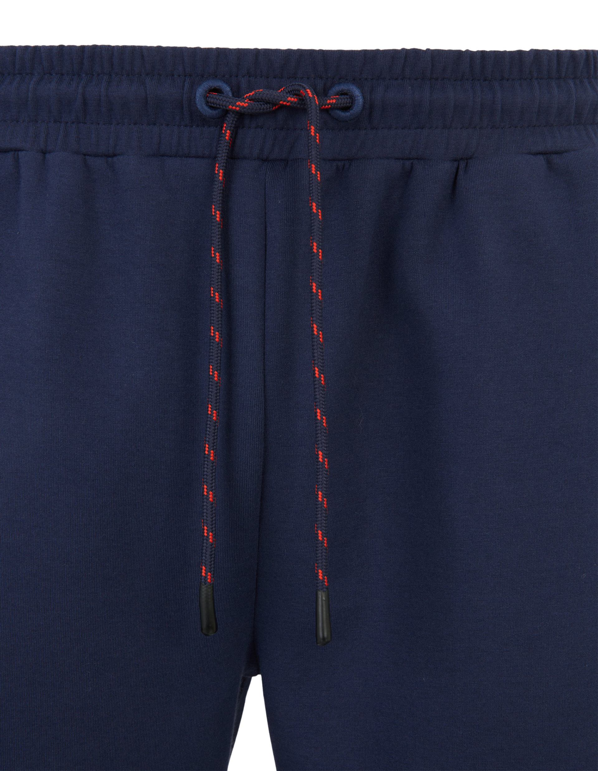 Dunkelblaue Jogginghose mit elastischem Bund und rotem Kordelzug, aus weichem Stoff für bequemen Sitz und sportlichen Stil.