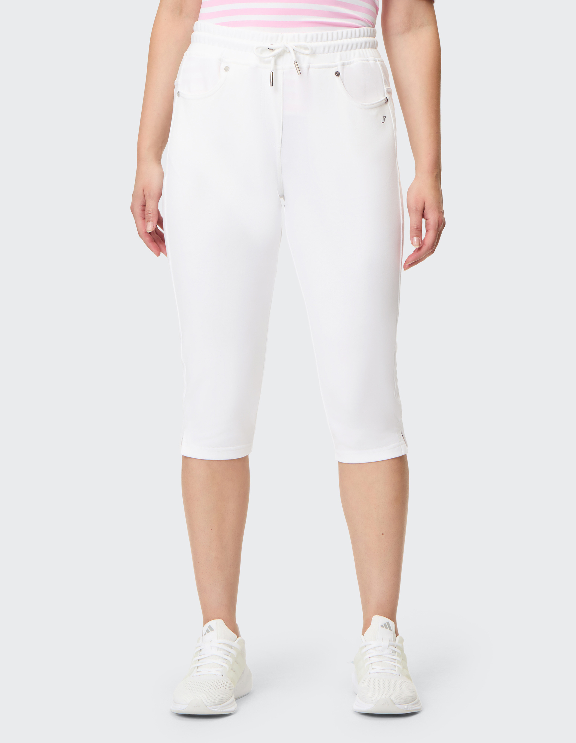 Weiße, knielange Jogginghose mit elastischem Bund, Kordelzug und seitlichen Taschen, aus weichem Baumwollstoff gefertigt.