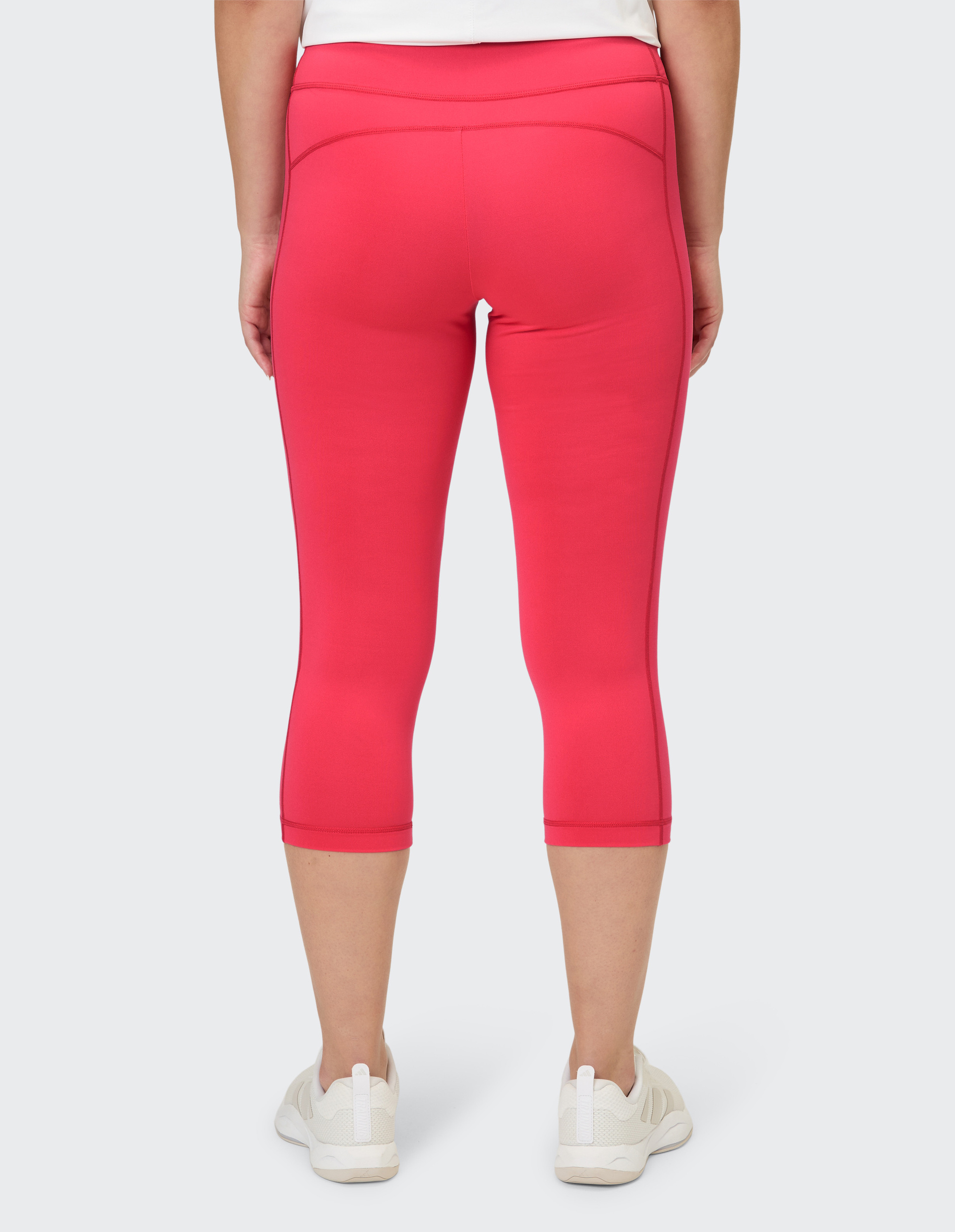 Rote Capri-Leggings mit einer dezenten, figurformenden Passform.